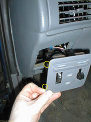 Dashboard light dimmer panel. The yellow circles highlight two of the spring clips that hold the panel in place.