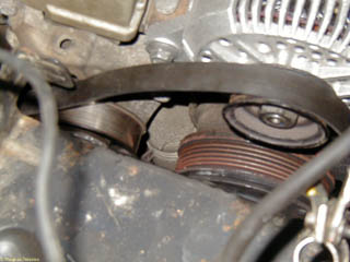 Serpentine belt placed around alternator pulley and on the wrong side of the idler pulley