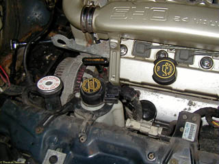 Remove cover with emission information from the top of the radiator to expose the overfflow bottle